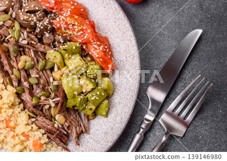 A bowl with beef, porridge, mushrooms, vegetables, sauce, and spices. Beef bowl 139146980