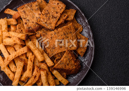 Croutons or crackers made from rye bread with garlic, salt, and spices. Croutons with salt Croutons or crackers made from rye bread with garlic, salt, and spices. Croutons with salt 139146996