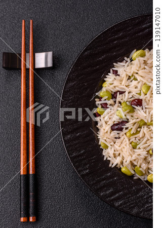 Asian food with rice, edamame, carrots, tofu, and spices. Rice with edamame Asian food with rice, edamame, carrots, tofu, and spices. Rice with edamame 139147010