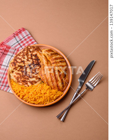 Dajaj Mashwi, an Arabic dish with rice and chicken, salt, and spices. Dajaj Mashwi as a background Dajaj Mashwi, an Arabic dish with rice and chicken, salt, and spices. Dajaj Mashwi as a background 139147017