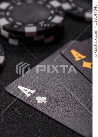 Playing cards and chips on a table, a gambling game of blackjack or baccarat. Cards and chips Playing cards and chips on a table, a gambling game of blackjack or baccarat. Cards and chips 139147046