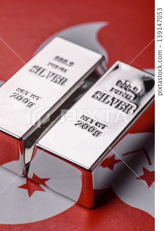 A silver bar, white metal against a backdrop of hong kong flag, as a concept. A silver bar A silver bar, white metal against a backdrop of hong kong flag, as a concept. A silver bar 139147053