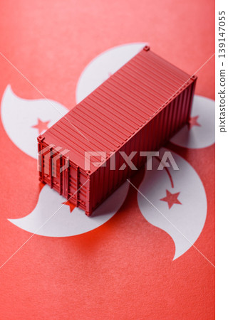 Cargo container on the hong kong flag as a conceptual backdrop for goods export. Cargo container Cargo container on the hong kong flag as a conceptual backdrop for goods export. Cargo container 139147055