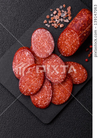 Sliced smoked pepperoni or salami as a pizza topping. Pepperoni sausage Sliced smoked pepperoni or salami as a pizza topping. Pepperoni sausage 139147063