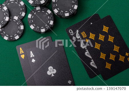 Playing cards and chips on a green cloth, a gambling game of blackjack or baccarat. Cards and chips 139147070