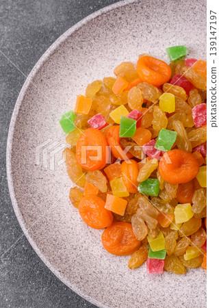 Dried apricots, raisins, and candied fruits as ingredients for baked goods and sweets. Dried fruits Dried apricots, raisins, and candied fruits as ingredients for baked goods and sweets. Dried fruits 139147197