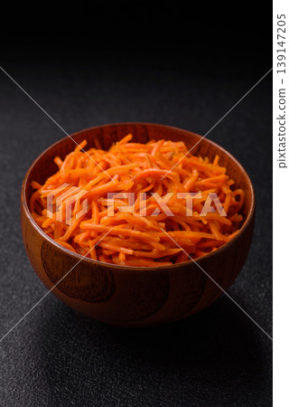 Spicy Korean carrot salad, grated with salt and spices, an Asian dish. Korean carrots Spicy Korean carrot salad, grated with salt and spices, an Asian dish. Korean carrots 139147205