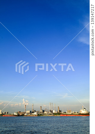 Ocean liners at Bangkok shipping container terminal, One of the Asian modernize harbor and global trade, background with bangkok cityscape on cloudy day. 139147217