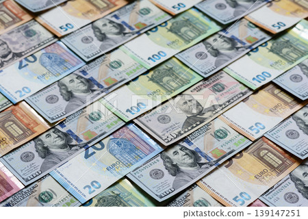 Euro and dollar banknotes, exchange, sales, economic tariffs and taxes. Euros and dollars Euro and dollar banknotes, exchange, sales, economic tariffs and taxes. Euros and dollars 139147251