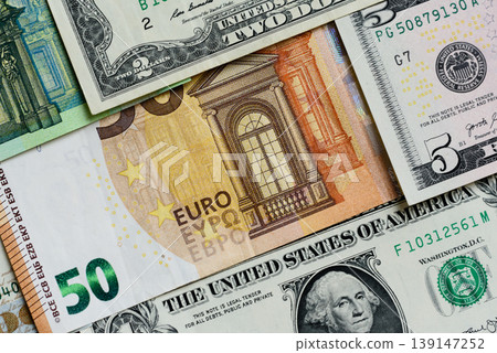 Euro and dollar banknotes, exchange, sales, economic tariffs and taxes. Euros and dollars Euro and dollar banknotes, exchange, sales, economic tariffs and taxes. Euros and dollars 139147252