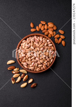 Salted pistachio nuts in shells as a healthy, high calorie food ingredient. Pistachio nuts Salted pistachio nuts in shells as a healthy, high calorie food ingredient. Pistachio nuts 139147274