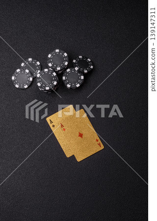 Playing cards and chips on a table, a gambling game of blackjack or baccarat. Cards and chips Playing cards and chips on a table, a gambling game of blackjack or baccarat. Cards and chips 139147311
