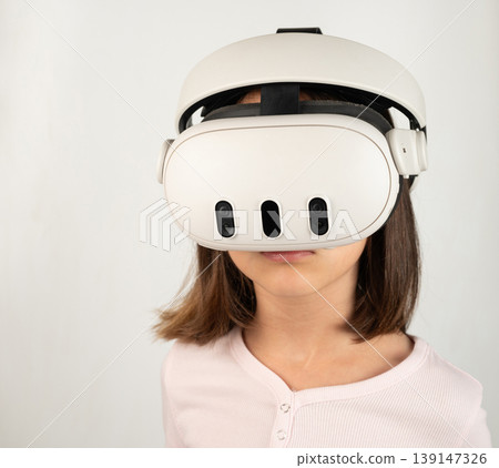 Girl using virtual reality headset indoors at home Girl using virtual reality headset indoors at home 139147326