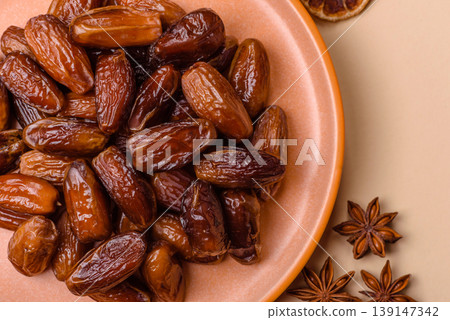 Dried dates on a ceramic plate for Ramadan or Iftar. Dates fruit as a background Dried dates on a ceramic plate for Ramadan or Iftar. Dates fruit as a background 139147342
