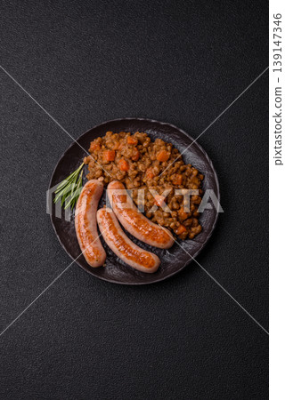 Lentil, carrot, and tomato stew with sausages, a European dish. Lentils with sausages Lentil, carrot, and tomato stew with sausages, a European dish. Lentils with sausages 139147346
