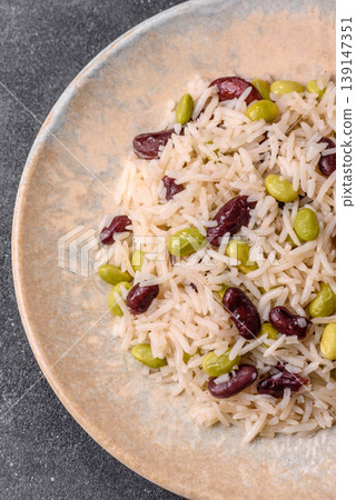 Asian food with rice, edamame, carrots, tofu, and spices. Rice with edamame Asian food with rice, edamame, carrots, tofu, and spices. Rice with edamame 139147351