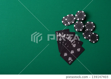 Playing cards and chips on a green cloth, a gambling game of poker. Cards and chips Playing cards and chips on a green cloth, a gambling game of poker. Cards and chips 139147403