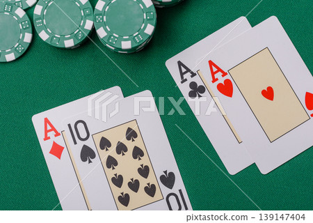 Playing cards and chips on a green cloth, a gambling game of blackjack or baccarat. Cards and chips Playing cards and chips on a green cloth, a gambling game of blackjack or baccarat. Cards and chips 139147404