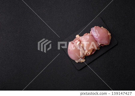 Raw chicken thigh fillet, boneless and skinless, for roasting. Raw thigh fillet 139147427