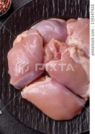 Raw chicken thigh fillet, boneless and skinless, for roasting. Raw thigh fillet Raw chicken thigh fillet, boneless and skinless, for roasting. Raw thigh fillet 139147428