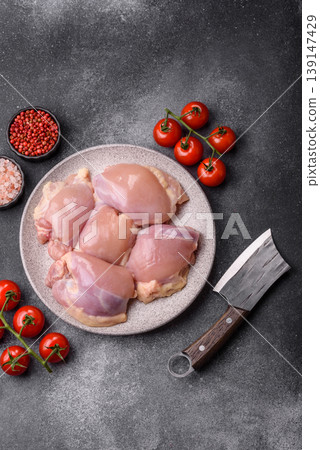 Raw chicken thigh fillet, boneless and skinless, for roasting. Raw thigh fillet 139147429