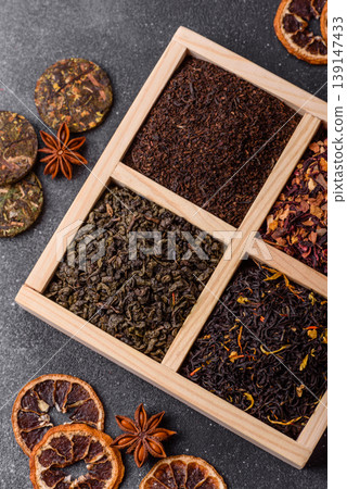 A box of various dry teas, black, green, herbal, and fruit. A set of different tea varieties 139147433