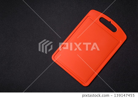 An empty plastic cutting board as a kitchen utensil. An empty plastic cutting board 139147455