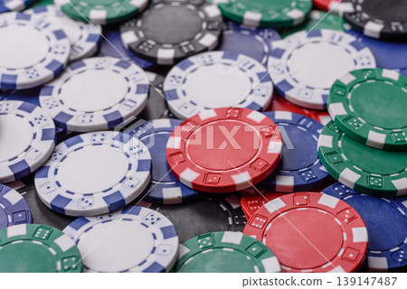 Multicolored casino chips as a conceptual backdrop for poker, blackjack. Multicolored casino chips 139147487