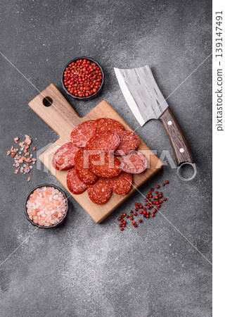 Sliced smoked pepperoni or salami as a pizza topping. Pepperoni sausage Sliced smoked pepperoni or salami as a pizza topping. Pepperoni sausage 139147491