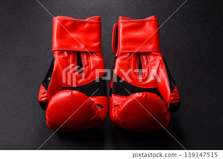 Two red boxing gloves for a fight, or as a symbol of overcoming illness. Red boxing gloves 139147515
