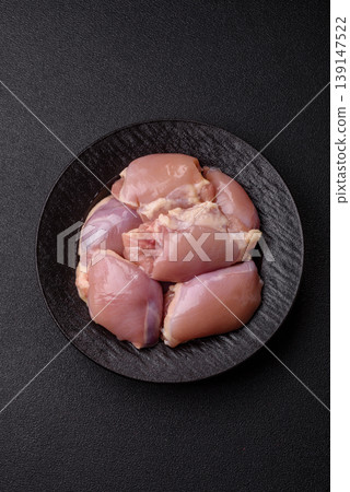 Raw chicken thigh fillet, boneless and skinless, for roasting. Raw thigh fillet Raw chicken thigh fillet, boneless and skinless, for roasting. Raw thigh fillet 139147522