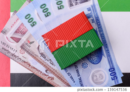 Cargo container on the uae flag as a conceptual backdrop for goods export. Cargo container Cargo container on the uae flag as a conceptual backdrop for goods export. Cargo container 139147536