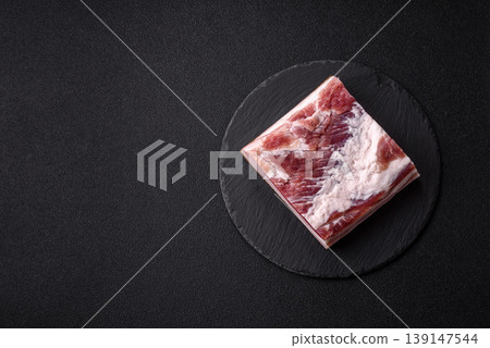 Raw fresh bacon slices with layers of meat or prosciutto prepared for frying. Raw bacon Raw fresh bacon slices with layers of meat or prosciutto prepared for frying. Raw bacon 139147544