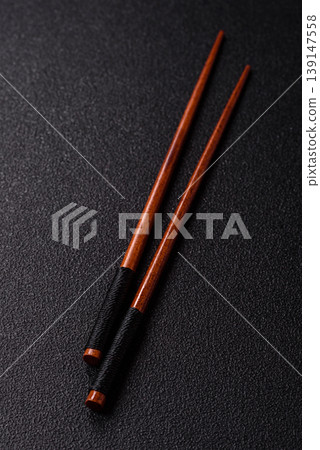 Wooden bamboo chopsticks for sushi and other Asian food with a blank background. Wooden chopsticks 139147558
