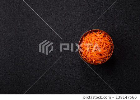 Spicy Korean carrot salad, grated with salt and spices, an Asian dish. Korean carrots Spicy Korean carrot salad, grated with salt and spices, an Asian dish. Korean carrots 139147560