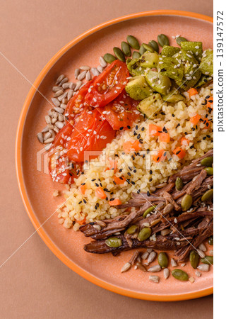 A bowl with beef, porridge, mushrooms, vegetables, sauce, and spices. Beef bowl A bowl with beef, porridge, mushrooms, vegetables, sauce, and spices. Beef bowl 139147572
