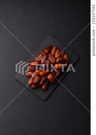 Dried dates on a ceramic plate for Ramadan or Iftar. Dates fruit as a background 139147582