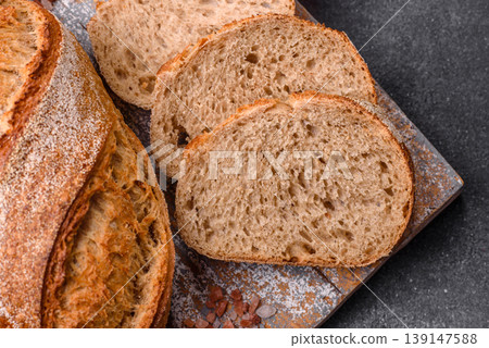 A loaf of homemade whole grain rye bread for the dinner table. A loaf of rye bread A loaf of homemade whole grain rye bread for the dinner table. A loaf of rye bread 139147588