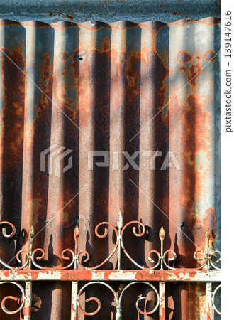 Old Galvanized Iron, Grunge rusted metal texture, rust and oxidized metal background. Old metal iron panel. with rusty metal fence. Old Galvanized Iron, Grunge rusted metal texture, rust and oxidized metal background. Old metal iron panel. with rusty metal fence. 139147616
