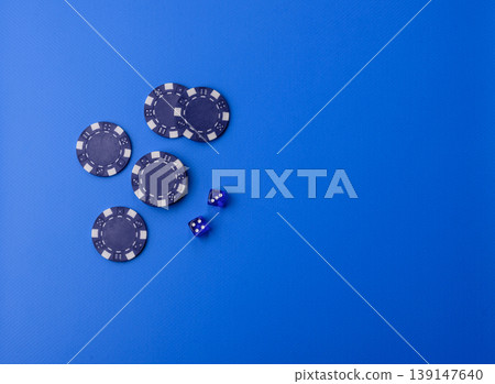 Casino dice and chips on a colored background, poker, gambling with bets. Dice and chips Casino dice and chips on a colored background, poker, gambling with bets. Dice and chips 139147640