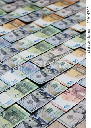 Euro and dollar banknotes, exchange, sales, economic tariffs and taxes. Euros and dollars Euro and dollar banknotes, exchange, sales, economic tariffs and taxes. Euros and dollars 139147654