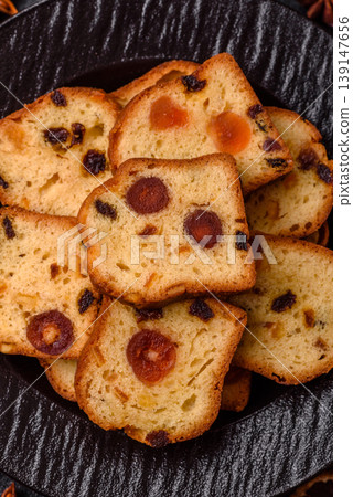 Fruit cake, a dessert with cherries, plums, and raisins for a festive Christmas table. Fruit cake Fruit cake, a dessert with cherries, plums, and raisins for a festive Christmas table. Fruit cake 139147656