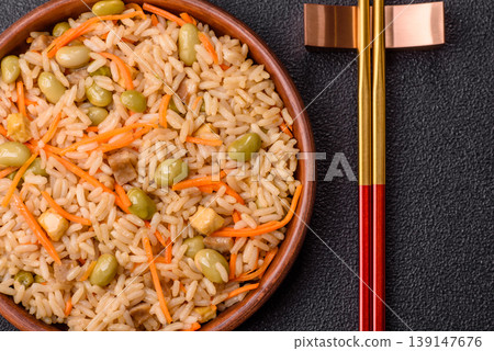 Asian food with rice, edamame, carrots, tofu, and spices. Rice with edamame and carrots Asian food with rice, edamame, carrots, tofu, and spices. Rice with edamame and carrots 139147676