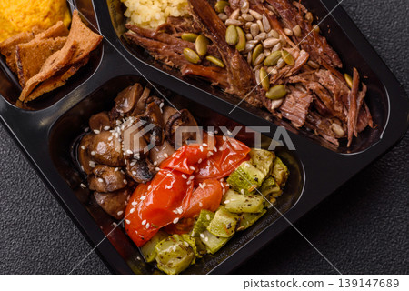 A bowl with beef, porridge, mushrooms, vegetables, sauce, and spices. Beef bowl 139147689