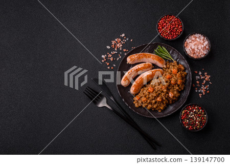 Lentil, carrot, and tomato stew with sausages, a European dish. Lentils with sausages 139147700