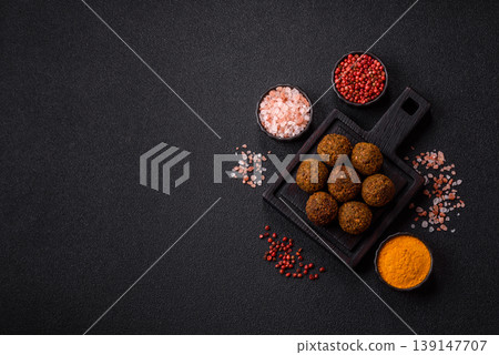 Falafel, a hearty Arabic dish made from boiled chickpeas for vegetarians. Chickpea falafel Falafel, a hearty Arabic dish made from boiled chickpeas for vegetarians. Chickpea falafel 139147707