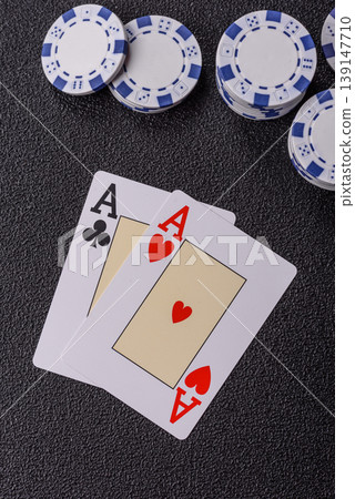 Playing cards and chips on a table, a gambling game of blackjack or baccarat. Cards and chips Playing cards and chips on a table, a gambling game of blackjack or baccarat. Cards and chips 139147710