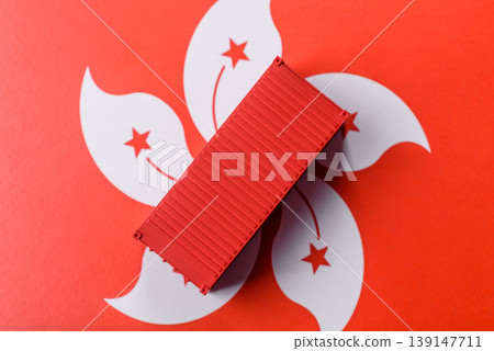 Cargo container on the hong kong flag as a conceptual backdrop for goods export. Cargo container Cargo container on the hong kong flag as a conceptual backdrop for goods export. Cargo container 139147711