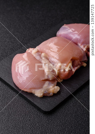Raw chicken thigh fillet, boneless and skinless, for roasting. Raw thigh fillet 139147725