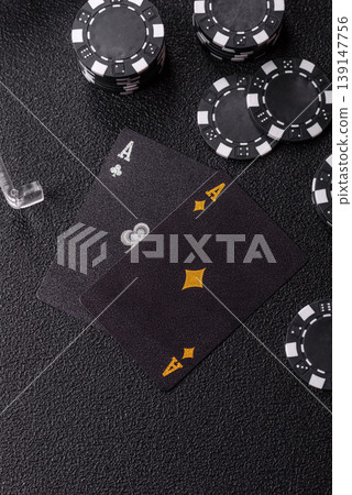 Playing cards and chips on a table, a gambling game of blackjack or baccarat. Cards and chips Playing cards and chips on a table, a gambling game of blackjack or baccarat. Cards and chips 139147756
